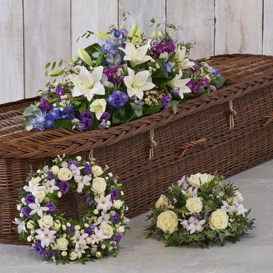 Visual comparison chart showing four different types of funeral floral arrangements: a crescent-shaped casket spray, a tall standing cross arrangement, a sympathy wreath, and a small vase arrangement for the home.